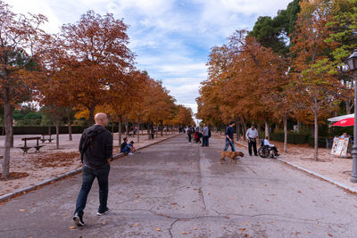 People walking on footpath in city