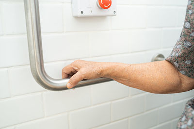Close-up of hands on wall at home