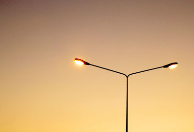 Low angle view of street light against sky during sunset