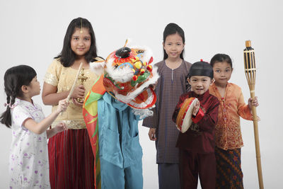 Portrait of smiling girl standing against people