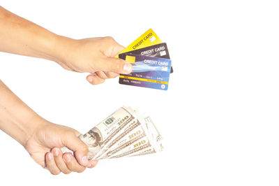 Midsection of person holding paper against white background