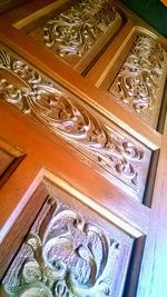 Low angle view of carvings on ceiling