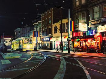 Illuminated railroad station in city at night