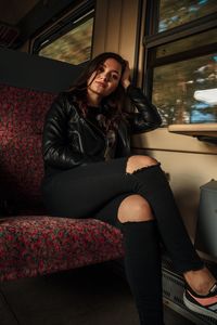 Portrait of a young woman sitting outdoors