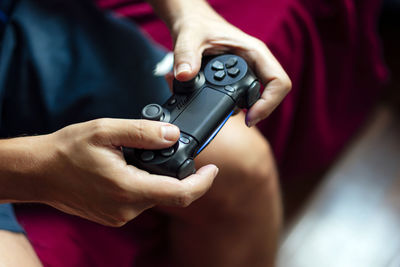 Close-up of a person playing the game console in the quarantine period