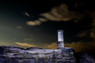 Smoke stack against sky at night