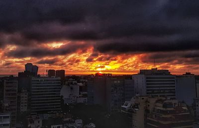 High angle view of buildings against dramatic sky