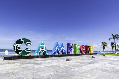 Graffiti on wall against blue sky