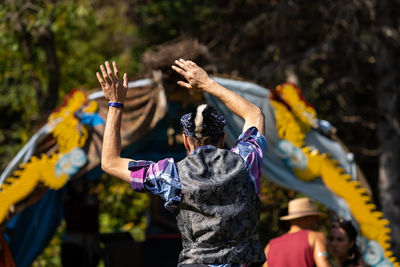 Rear view of people walking in park