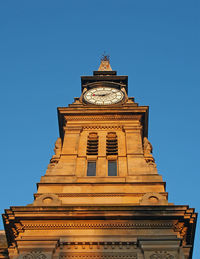 Low angle view of clock tower against sky