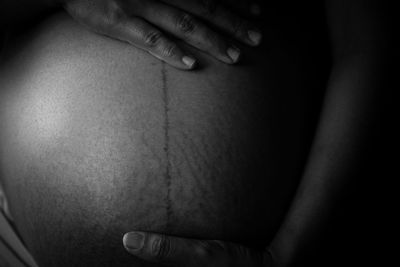 Midsection of woman wearing hat