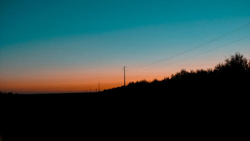 Scenic view of silhouette landscape against clear sky during sunset