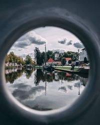 Reflection of trees in water against sky