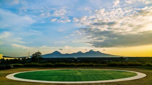 Scenic view of field against sky during sunset