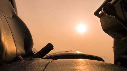 Empty car seats against clear sky during sunset