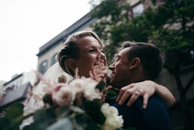 Rear view of couple kissing on flower