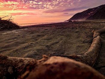 Scenic view of beach against dramatic sky