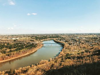 High angle view of river and cityscape against sky