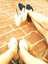 Low section of person standing on tiled floor