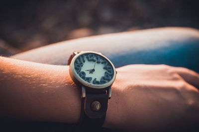 Close-up of hand holding clock