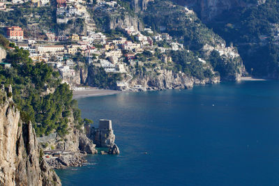 Scenic view of sea by buildings in city
