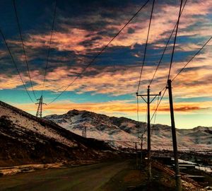 Low angle view of overhead cable car against sky