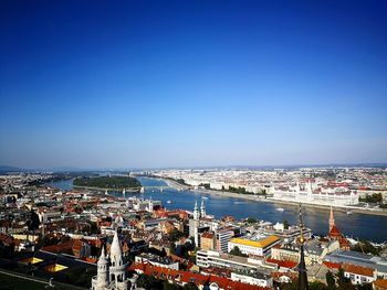 High angle view of townscape by sea against clear sky