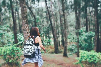 Rear view of woman in forest