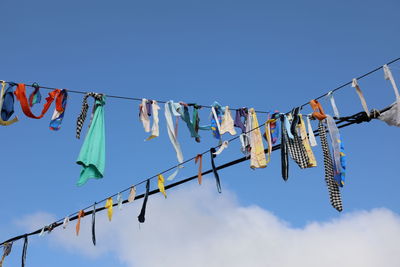 Low angle view of prayer flags against clear blue sky