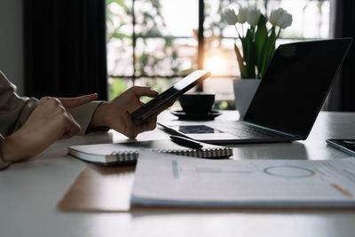 Midsection of businessman working on table