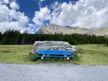 Information sign on field against sky