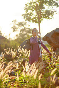 A woman drinking water during hiking 