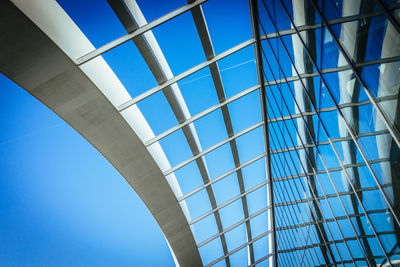 Low angle view of modern building against blue sky