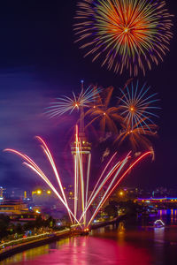 Low angle view of firework display at night