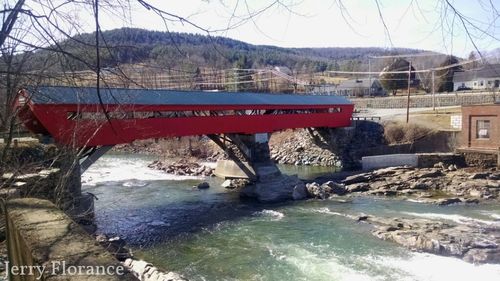 Bridge over river with buildings in background