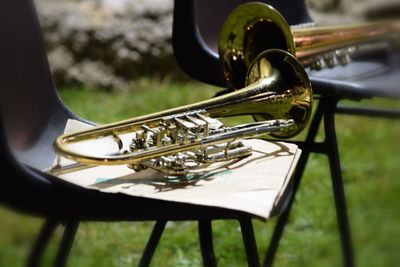 Close-up of trumpets on chairs