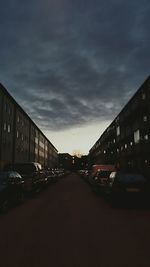 Road in city against cloudy sky