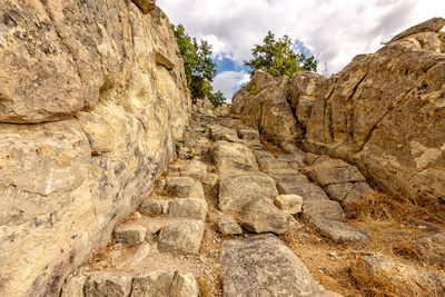 Low angle view of rock formation against sky