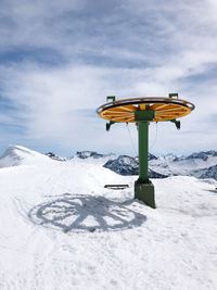 Lifeguard hut on snow covered field against sky