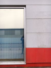 Cropped image of man reflecting on window glass