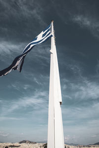 Low angle view of flag hanging on pole against sky