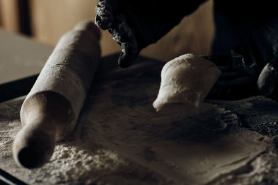 Cropped hand of man cutting wood