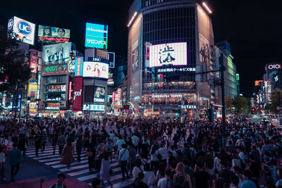 Group of people on street in city at night