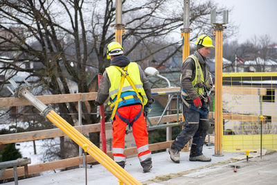 Two builder construction workers in the work process on building site 
