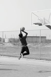 Full length of man playing basketball