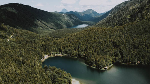 High angle view of lake amidst mountains against sky