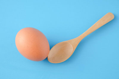 High angle view of eggs against blue background