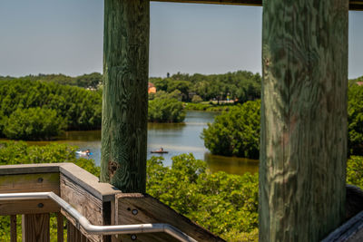 Trees by lake against sky