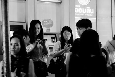 Young woman standing in window