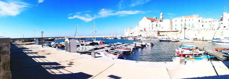 Boats moored at harbor in city